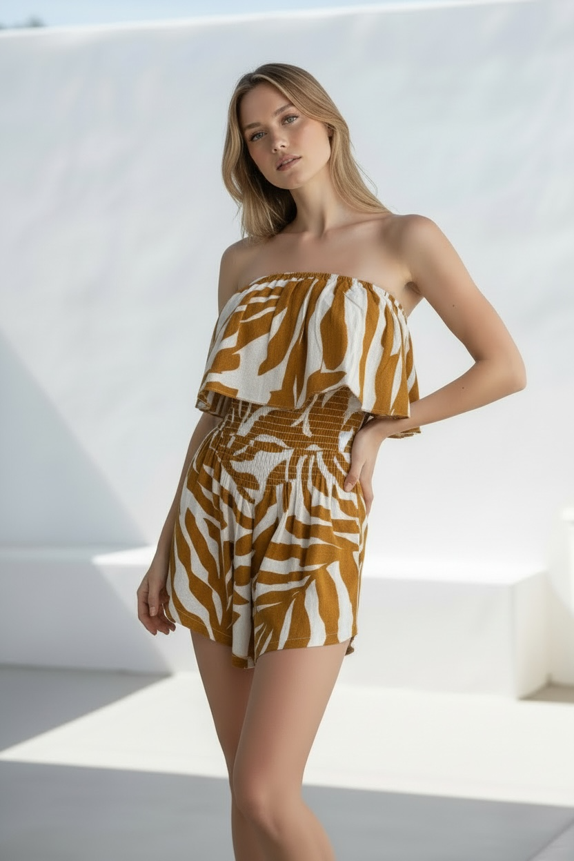 Woman wearing romper with a yelloew zwbra pattern 